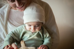  Soft, cozy ecru knit hat for babies and toddlers. Available in sizes 1M-3M, 3M-12M, 12M-24M, and 24M-6Y.