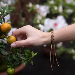 Braided bracelet in various colors including black, blue, gold, brown, orange mix, green mix, pink mix, purple mix, brown mix, and black mix. The bracelet features a delicate chain design.