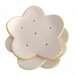 Handmade ceramic flower-shaped soap dish with scalloped edges, cream white with gold trim, bathroom accessory.