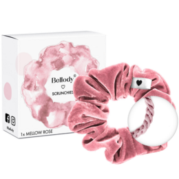 Soft, pink velvet scrunchie with a heart-shaped accent. Made of high-quality materials for a comfortable and stylish hair accessory.