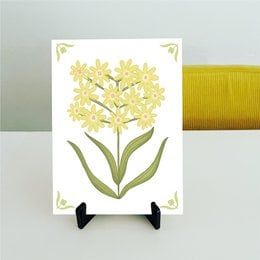 Decorative tile with yellow flowers and green details. Suitable for use in home decor or as a wall hanging.