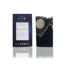 A black and white bar soap with a moon and celestial design, suitable for facial cleansing. The soap is made with natural ingredients and is packaged in a simple, minimalist style.