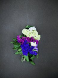 Vibrant bouquet of white and purple flowers, including chrysanthemums and carnations, with green foliage.