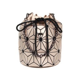 Geometric patterned beige and black handbag with drawstring closure and gold-tone hardware.