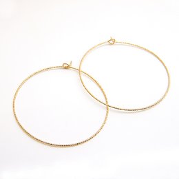 Slim, gold-toned hoop earrings with a minimalist, modern design.