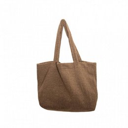 Large brown tote bag made of durable canvas material, featuring a simple and minimalist design with sturdy handles for comfortable carrying.