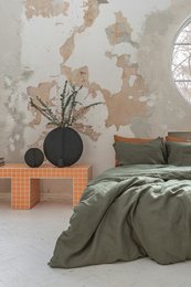 Linen bedding set in a Nordic moss color, featuring a minimalist design with natural elements and a cozy, earthy aesthetic.