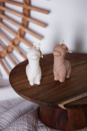  Beige alpaca-shaped pillar candles with a natural, earthy aesthetic.