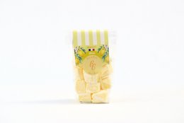  "Pale yellow cube marshmallows, lemon flavored, artisanal, striped packaging, French Alsace brand"