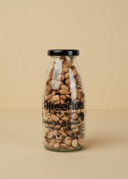 Premium cashews and peanuts mix, oven roasted with sea salt, in a glass bottle containing 150g of product.
