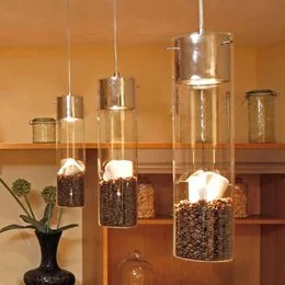 A modern, cylindrical hanging lamp with a black or chrome finish, suitable for pendant lighting in a room.