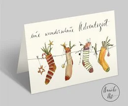 A folded DIN A6 Christmas card with an envelope, featuring a whimsical illustration of colorful, patterned socks or stockings, likely representing the Advent season.