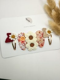 Pink and rose gold hair clips with a sparkly, textured design. Suitable for kids' hairstyles.