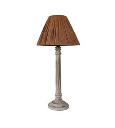 Vintage table lamp with a wooden base and raffia shade. The lamp has a neutral color palette and a rustic, natural aesthetic.