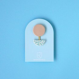 Porcelain brooch with a round shape, featuring a polka dot pattern in mint and nude color variants.