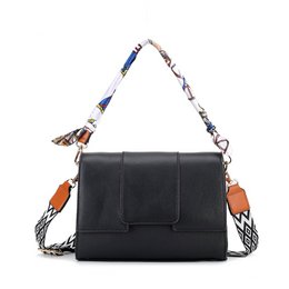  Mint green leather handbag with colorful patterned straps, compact structured design, crossbody bag