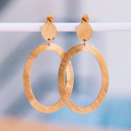  Large oval gold statement earrings with a textured, hammered finish.