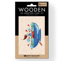 Wooden folded greeting card with a colorful illustration of a ship sailing on a blue sea, surrounded by flowers and hearts. The card is made of wood and comes with an envelope.