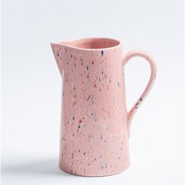 A pink speckled ceramic pitcher and matching cups, perfect for serving drinks at parties or gatherings. The pitcher has a 1.5L capacity and a comfortable handle for easy pouring.