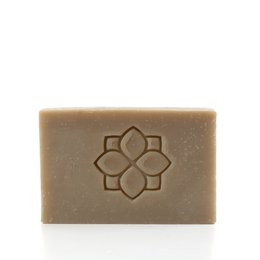 Green clay soap bar with floral design, part of the Purify product line.