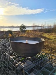Rustic, organic-looking bowl candle with an old, weathered exterior. Made of wax, available in medium and large sizes.