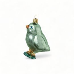 Green glass ornament in the shape of a chick with a red comb and beak.