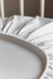  "White fitted bottom sheet polyester-cotton blend, elastic edges, available in multiple sizes"