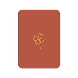  Greeting card with gold foil clover design on a rust-colored background. Suitable for various occasions.