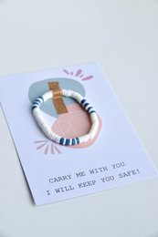 Ceramic compass-shaped cards in a warm, earthy color palette. Features a simple compass design, perfect for friendship or adventure-themed gifts.