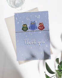 "Whimsical thank you card featuring three colorful owls perched on a branch in the rain. The card has a simple 'Thank you' message."