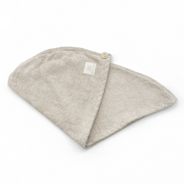 Soft, absorbent bamboo hair turban in beige, blush pink, cream, light blue, and light grey colors. Made of natural bamboo fabric for gentle hair drying.