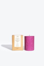 Tall, round, pink candle with embossed rune design. Scented candle made of natural wax.