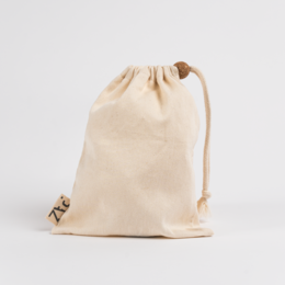 Beige cotton toiletry pouch with drawstring closure, suitable for storing personal care items.