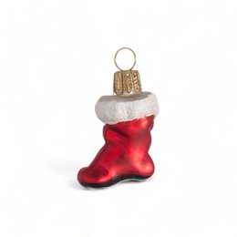 A red and white Christmas stocking ornament with a gold top.