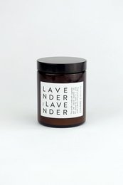 Lavender-scented candle in a glass jar with a black lid. The candle has a simple, minimalist design with the text "LAVENDER LAVENDER" printed on the label.