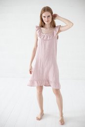 Linen nightdress in a variety of colors and sizes, including natural linen, off-white, white, pale dogwood, frozen cranberry, and rust. The dress features a sleeveless design with a ruffled hem.