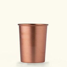  Pure copper glass cup with a cylindrical shape and metallic copper finish.