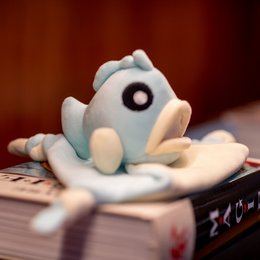 Soft, plush grouper-shaped stuffed animal with large eyes and a cute expression, perfect for cuddling and playing.