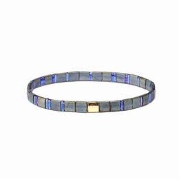 A beaded bracelet with alternating gray and blue rectangular beads, featuring a gold-colored clasp.