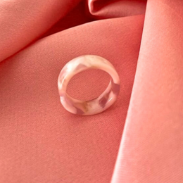 Elegant white and cream acrylic ring with a simple, minimalist design. Suitable for stacking with other rings.