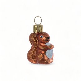 A small, brown glass ornament in the shape of a squirrel. The squirrel has a detailed, textured body and a bright, shiny finish.