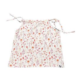 A white baby shirt with a floral print featuring small red, pink, and green flowers scattered across the fabric. The shirt has a loose, flowing silhouette and tie straps at the shoulders.