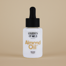 Organic almond oil in a 30ml bottle. Suitable for face, body, and hair care. Contains natural ingredients for nourishing and moisturizing skin.
