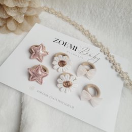  Colorful hair ties with star and flower shapes, perfect for adding a touch of sparkle to kids' hairstyles.