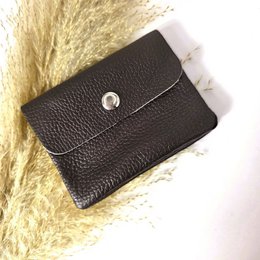  A compact, blush-colored leather wallet with a coin pocket and snap closure.