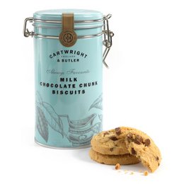 Cartwright & Butler milk chocolate chunk cookie tin. Rectangular tin container with light blue label. Contains round, golden-brown cookies with visible chocolate chunks.