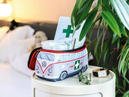 A red and gray Volkswagen VW T1 Bus 3D Neoprene Small Universal Bag with a first aid kit inside.
The product is a small, portable first aid kit in the shape of a classic Volkswagen T1 Bus. The bag is made of neoprene material and features the iconic Volkswagen logo and design. The bag is compact and universal, suitable for storing basic first aid supplies. The description highlights the product's style, shape, and intended use as a first aid kit.
