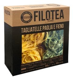 Tagliatelle pasta in a variety of colors, including yellow and green, packaged in a cardboard box.
