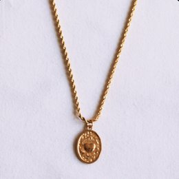 Twisted steel chain with an oval heart charm