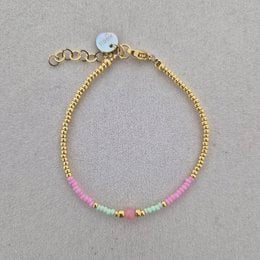 Gold beaded bracelet with colorful beads, pink and green accents, delicate chain design, adjustable closure.